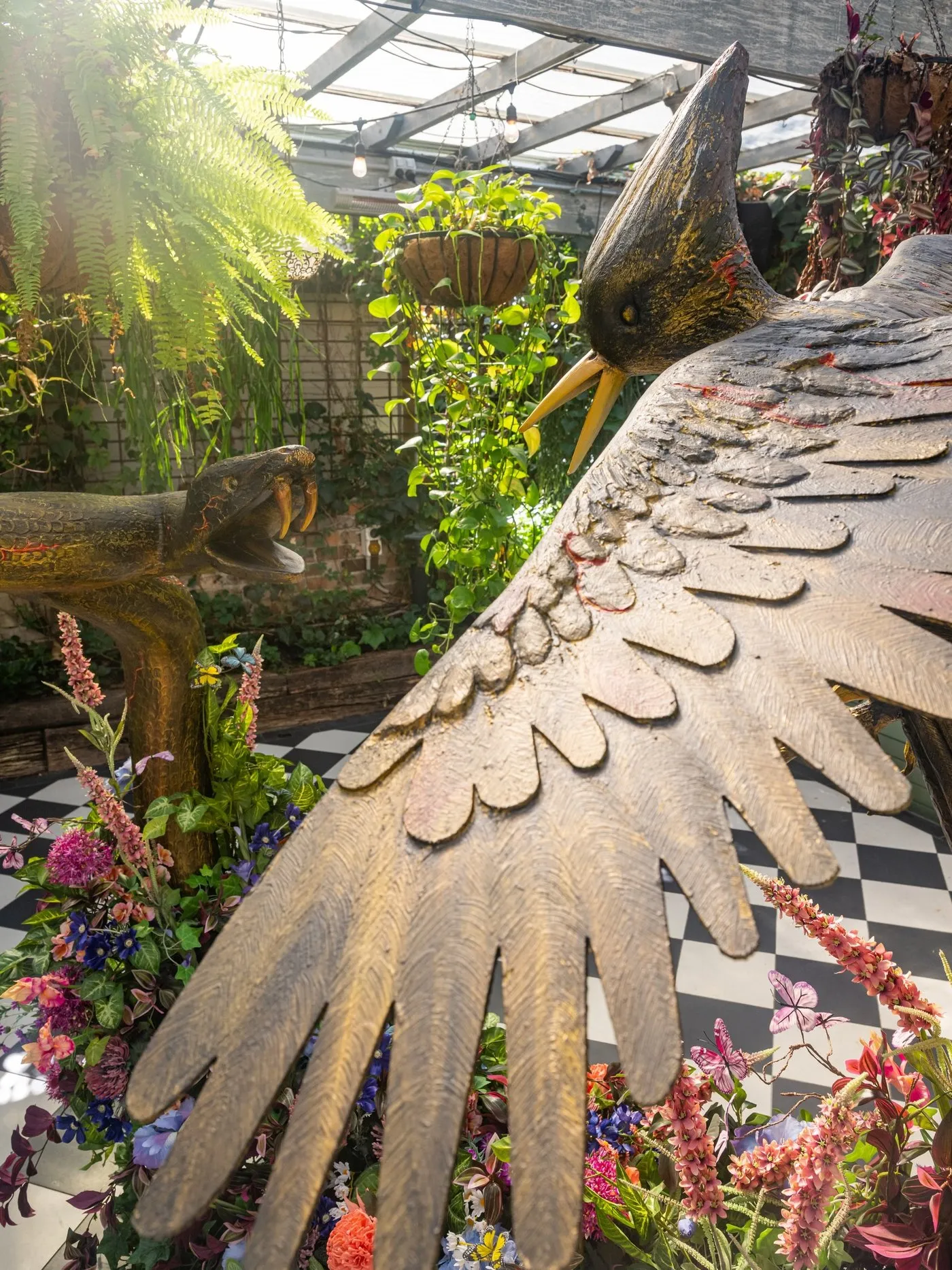 The mockingjay's wing, with the snake rearing beyond it